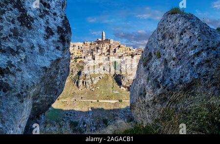 Long view across 'la Gravina' ravine to the Sassi of Matera at sunrise, Basilicata, Italy. A UNESCO World Heritage site.  The area of Matera has been Stock Photo