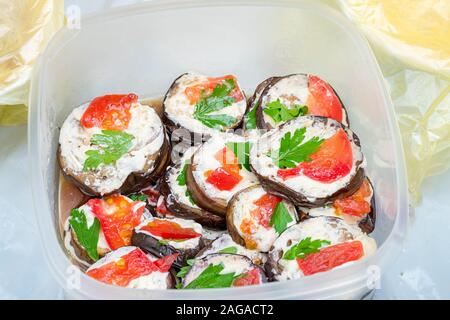 Fried eggplant in mayonnaise with garlic and pieces of red fish Stock Photo