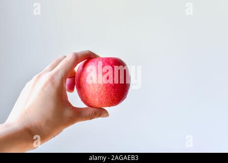 Hand Holding Red Apple Isolated on White Background Stock Photo