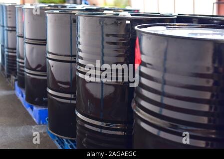 Black Oil Barrels or Steel Industrial Chemical Drums for Petrochemical Industry Stock Photo