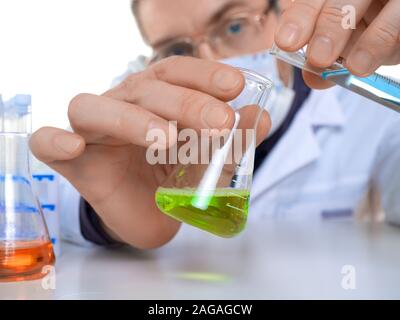 Close up view of a hands of male researcher carrying out scientific research in a lab. Selective focus. Stock Photo