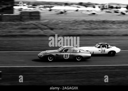 GOODWOOD, UNITED KINGDOM - Sep 09, 2017: A high angle grayscale shot of beautiful sports cars riding in Goodwood city of the UK Stock Photo