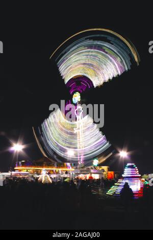 Vertical shot of lights dancing spreading happiness in a festive holiday market Stock Photo