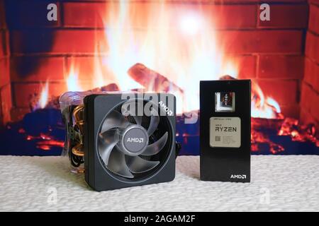 Bucharest, Romania - December 13, 2019: AMD Ryzen 7 3700X CPU processor unit next to its big Wraith Prism cooler. Fireplace in the background. Stock Photo
