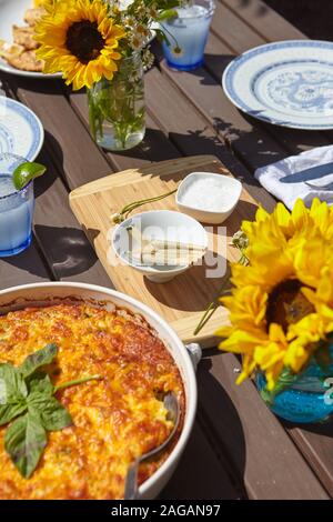 Vertical high angle shot of a beautiful dinner table with vases of sunflowers Stock Photo