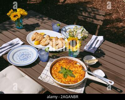 Beautiful high angle shot of a beautiful dinner table with vases of sunflowers Stock Photo