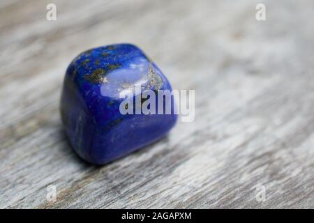 close up of blue gemstone lapis lazuli on wooden background with copy space Stock Photo