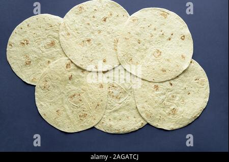 Overhead shot of tortilla bread on a dark blue surface Stock Photo