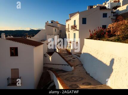 Winding, patterned cobbled street in the new part of the White Village of Frigiliana in typical Andalucían style, province of Malaga, Andalusia, Spain Stock Photo