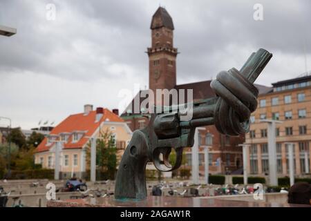 Malmo, Sweden: September 13, 2019: Statue of a gun with a knot as a non violence symbol designed by Carl Fredrik Reuterswärd, in the street of Malmo Stock Photo