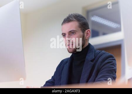 Programming. Man Working On Computer In IT Office, Sitting At Desk Writing Codes. Programmer Typing Data Code, Working On Project In Software Developm Stock Photo