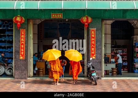Buddhist Monks Collecting Alms, Phnom Penh, Cambodia. Stock Photo
