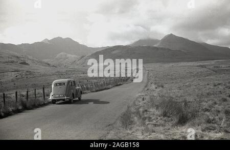 1950s, historical, motorcar of  the era parked on a  narrow country road at Long Mynd, Shropshire, England, a heath and moorland plateau, of which in 1965 large areas, almost all its upland area, were brought by the National Trust and designated as an area of outstanding natural beauty (ANOB). Stock Photo