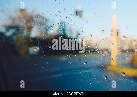 Closeup shot of wet glass looking at the street during rain Stock Photo