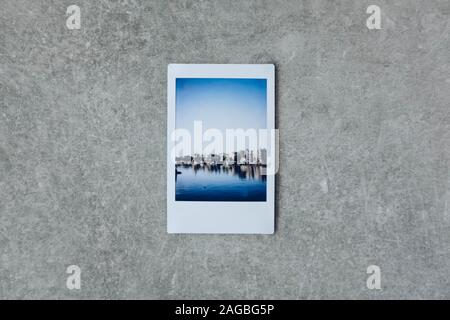 Polaroid pictures of the ocean and the cliff on a grey surface Stock Photo