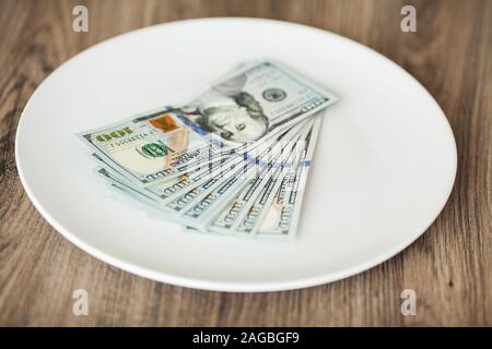 Plate with money. Greedy corruption concept. Bribe idea Stock Photo