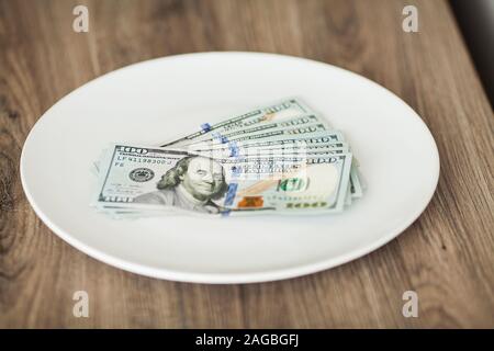 Plate with money. Greedy corruption concept. Bribe idea Stock Photo