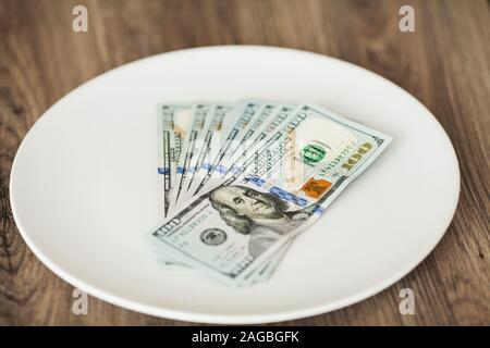 Plate with money. Greedy corruption concept. Bribe idea Stock Photo