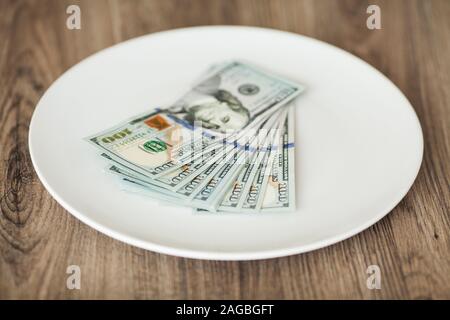 Plate with money. Greedy corruption concept. Bribe idea Stock Photo
