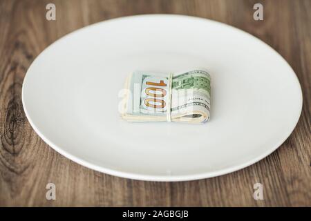 Plate with money. Greedy corruption concept. Bribe idea Stock Photo