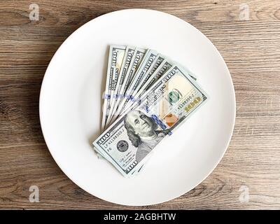 Plate with money. Dollars photo. Greedy corruption concept. Bribe idea Stock Photo