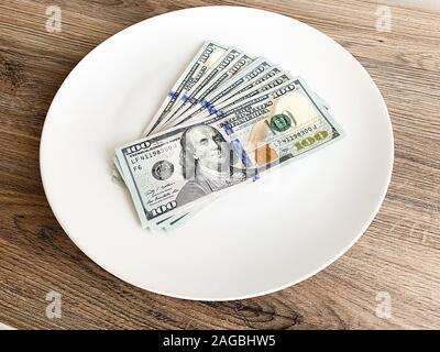 Plate with money. Dollars photo. Greedy corruption concept. Bribe idea Stock Photo