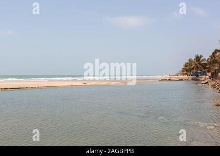Landscape of a sea surrounded by beaches and palms under a blue sky in Senegal Stock Photo