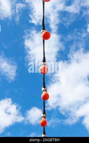 string of red light bulbs against blue sky at the The National Tramway Museum Crich Tramway Village, nr Matlock, Stock Photo