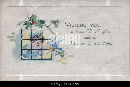 Vintage Postcard wishing a Merry Christmas young girl looking out window at bird Stock Photo