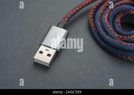 USB cable with cable against a dark background.. Stock Photo