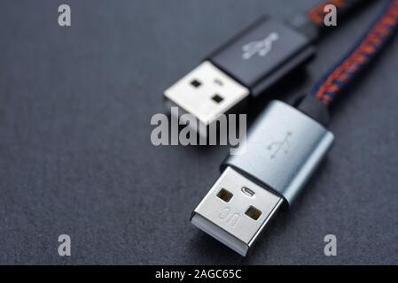 USB cable with cable against a dark background.. Stock Photo