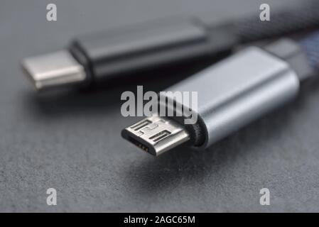 Micro USB cable with cable against a dark background.. Stock Photo