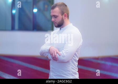 Young religious european muslim man praying inside the beautiful big mosque. Stock Photo