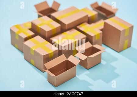 miniature cardboard postal boxes on blue background Stock Photo