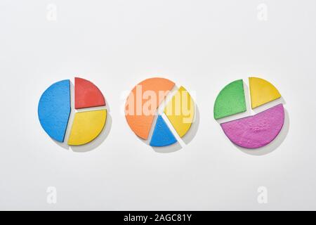 top view of multicolor pie charts on white background Stock Photo