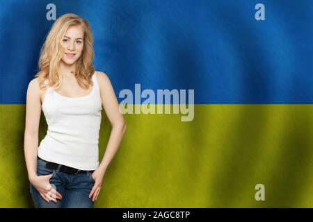 Cute blonde smiling woman with and Ukrainian flag. Tourist and education concept Stock Photo