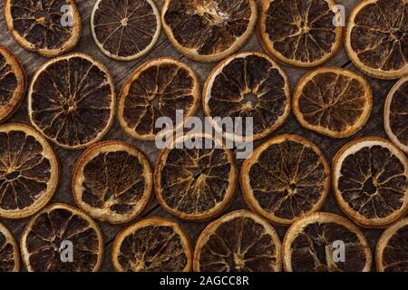 top view of dried orange slices on wooden background Stock Photo