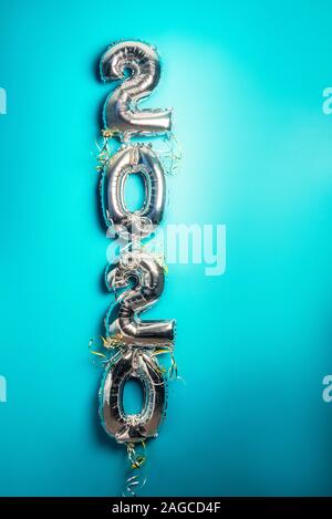 Balloon Bunting for celebration of New Year 2020 made from Silver Number Balloons. Holiday Party Decoration or postcard concept with top view and copy space. Toned in blue color Stock Photo