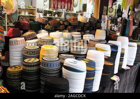 A lot of colourful chinese hat for sell in front supermarket in China Stock Photo