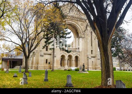 The Roman Catholic basilica and church of St. Boniface Cathedral {Cathédrale Saint-Boniface} overlooking the Red River in Winnipeg, Manitoba Stock Photo