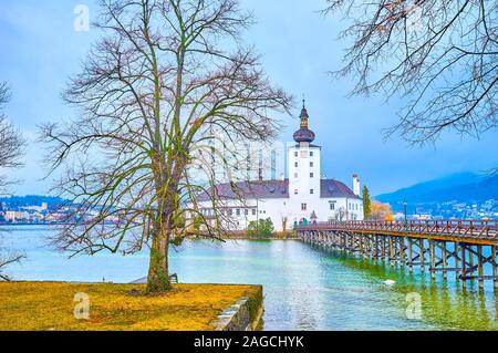 The beautiful medieval Schloss Ort castle located on the island in Traun lake and connects with old wooden bridge, Gmunden, Austria Stock Photo