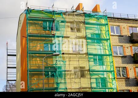 scaffolding arround the house to install thermal insulation of the apartment building facade Stock Photo