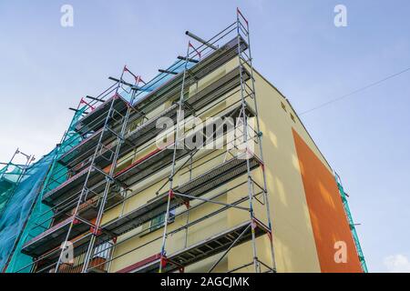 scaffolding arround the house to install thermal insulation of the apartment building facade Stock Photo