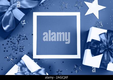 Present boxes on blue background. Stock Photo