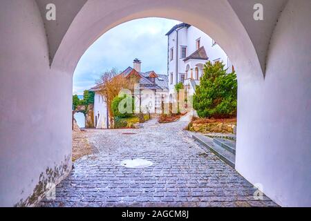 The scenic medieval buildings with arched passes on the bank of Traun Lake in Traunkirchen village, Austria Stock Photo