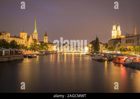 View over river Limmat at dusk, old town with Fraumuenster, St. Peter and Grossmuenster, old town, Zurich, Switzerland Stock Photo