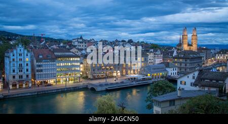 View of the old town at dusk, church Grossmuenster at the back, Limmatquai at the river Limmat in front, Zurich, Switzerland Stock Photo