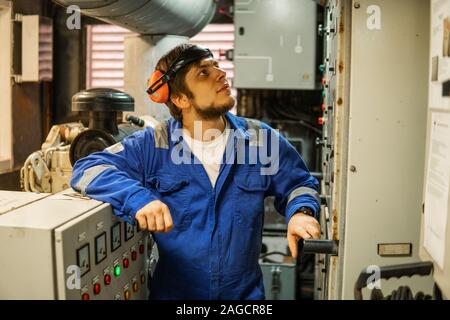 Marine engineer inspecting ship's engine or generators Stock Photo