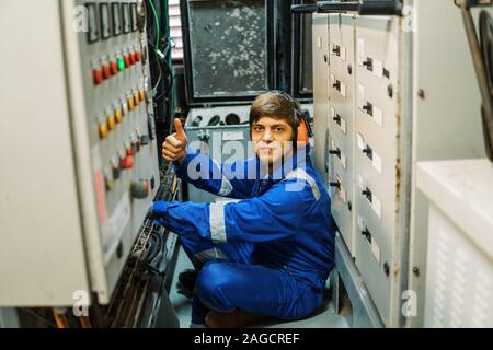 Marine engineer inspecting ship's engine or generators Stock Photo