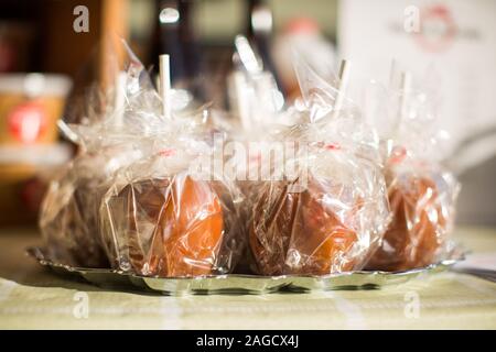 Lot of wrapped caramelized apples in a silver tray Stock Photo